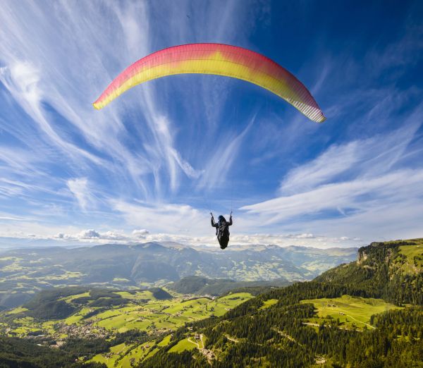 A Person Flying Through The Air On Top Of A Mountain