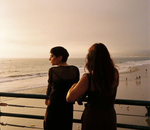 A Man And Woman Standing On A Beach