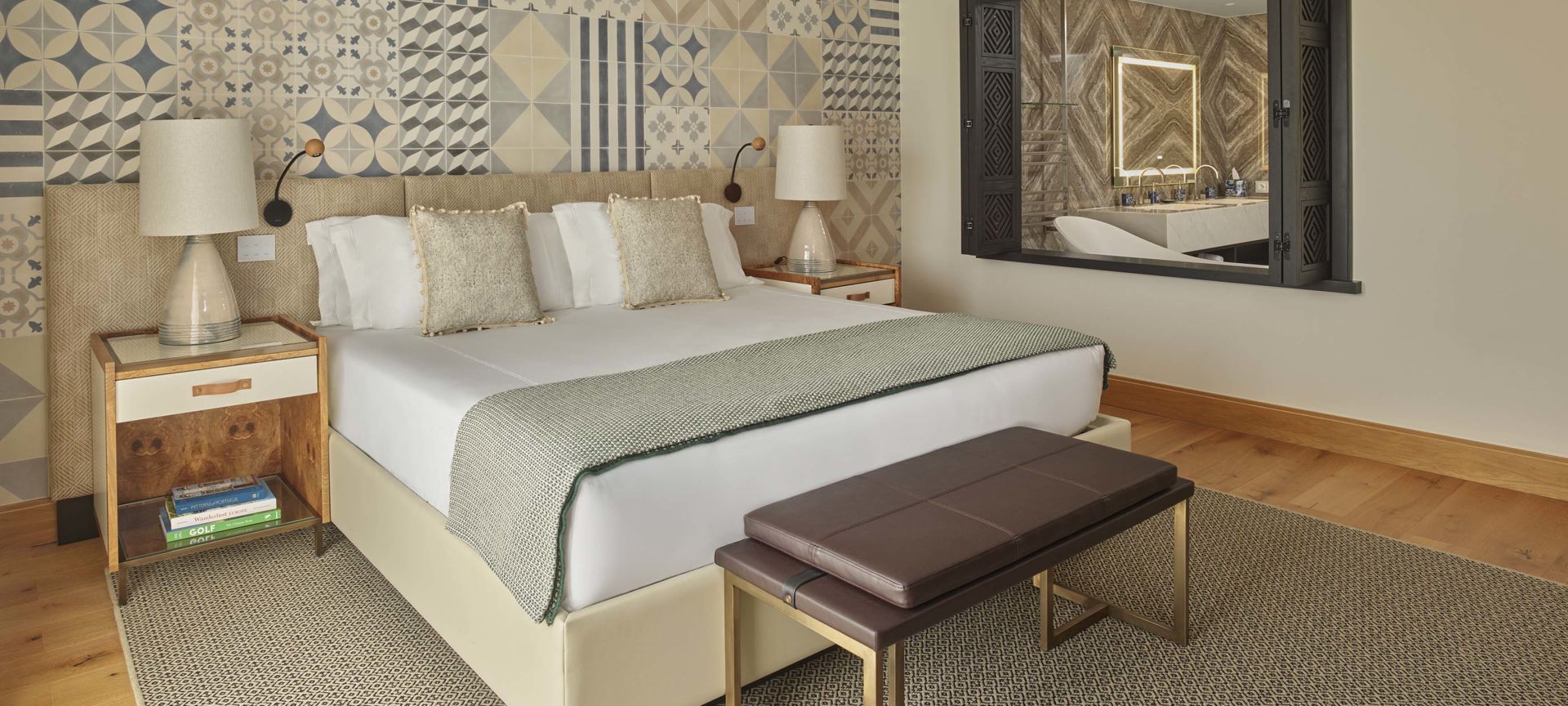 A Bedroom With A Bed And A Bench