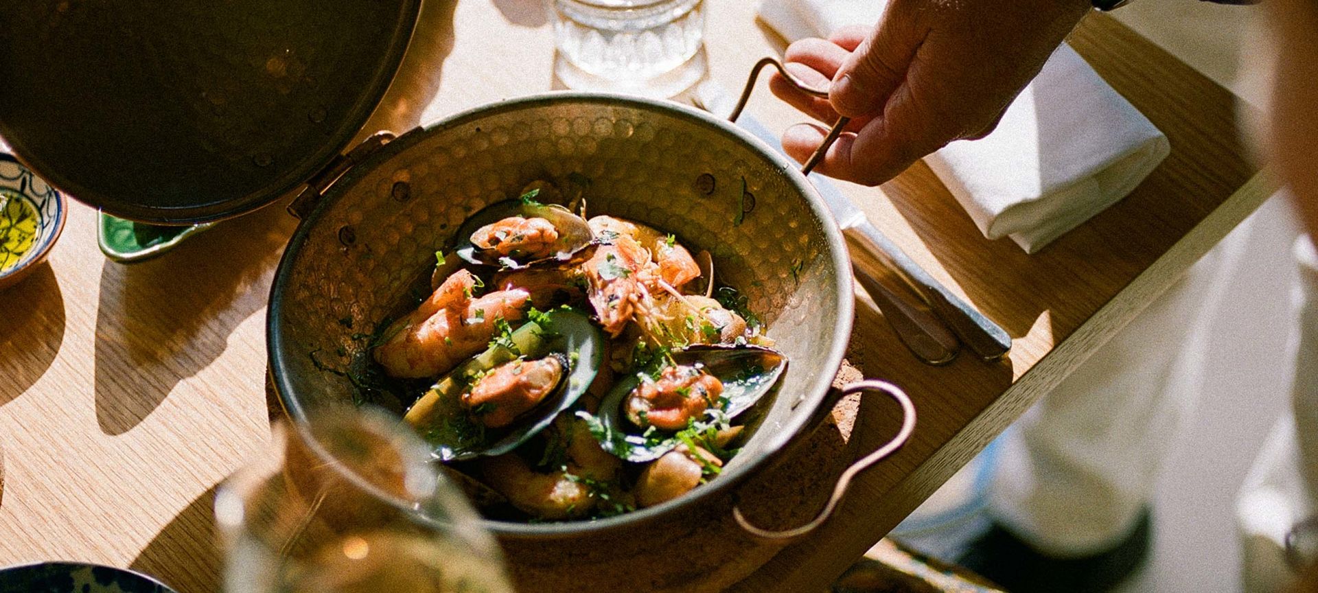 A Group Of People Around A Table With Food On It