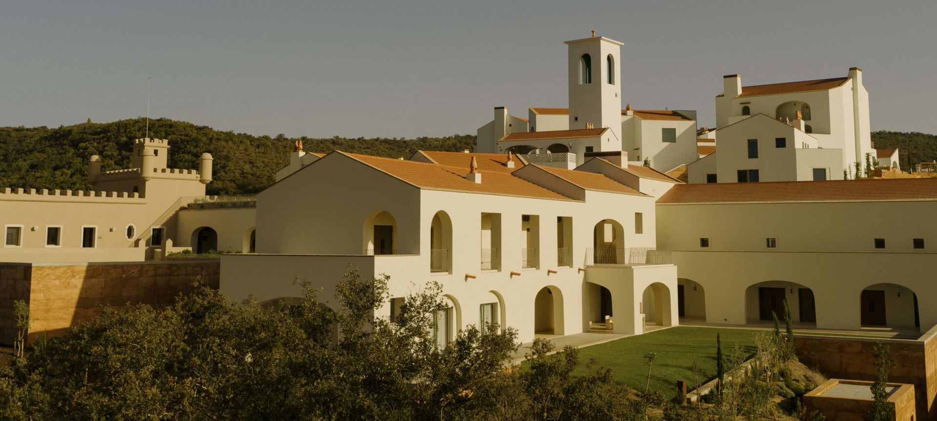 A Group Of Buildings With Trees In The Front