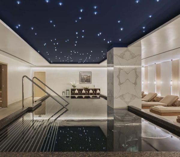 Indoor seating and pool at The Spa by Viceroy