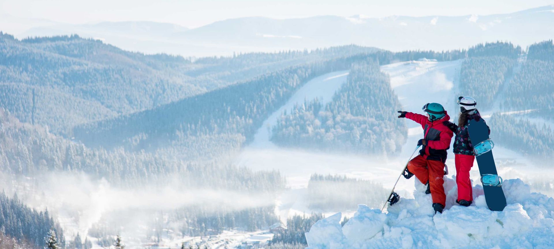 A Man Riding A Snowboard Down A Snow Covered Mountain