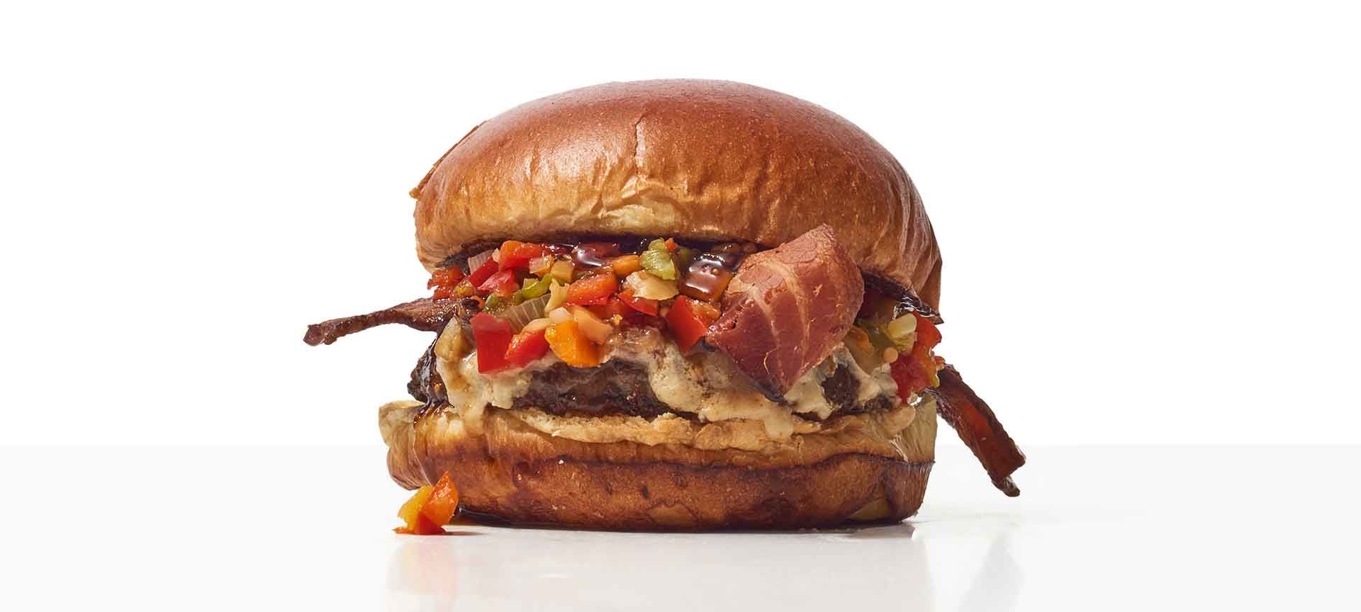 A Hamburger With Meat And Vegetables