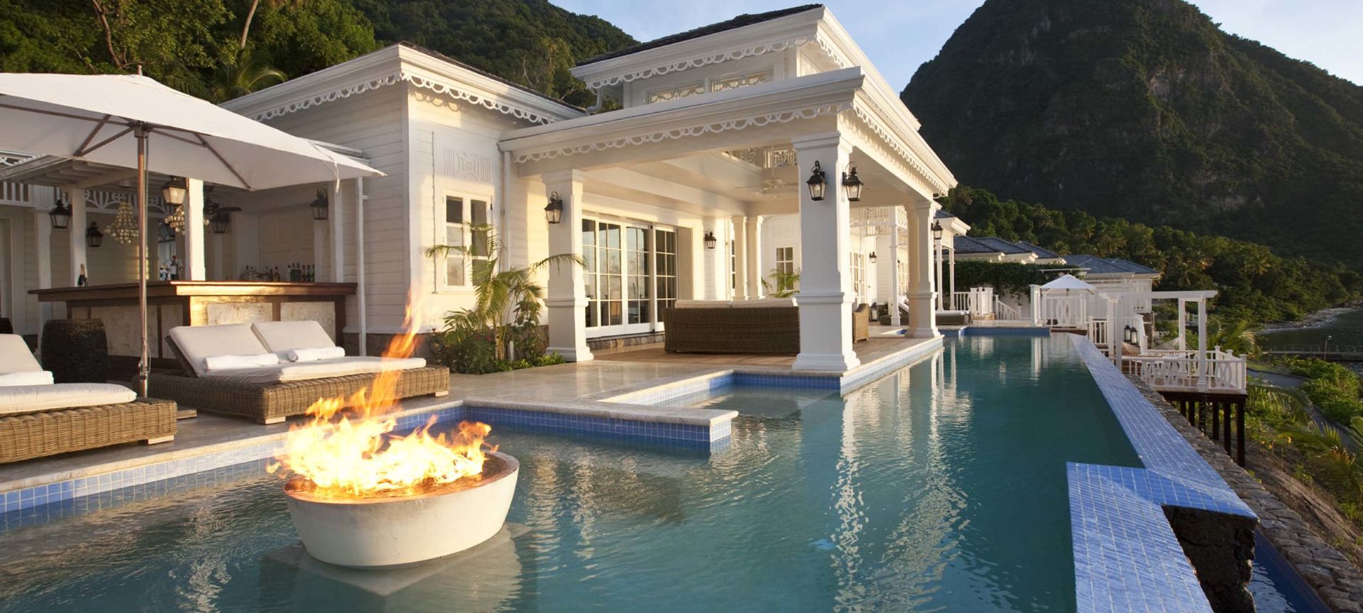 A Pool With A House In The Background