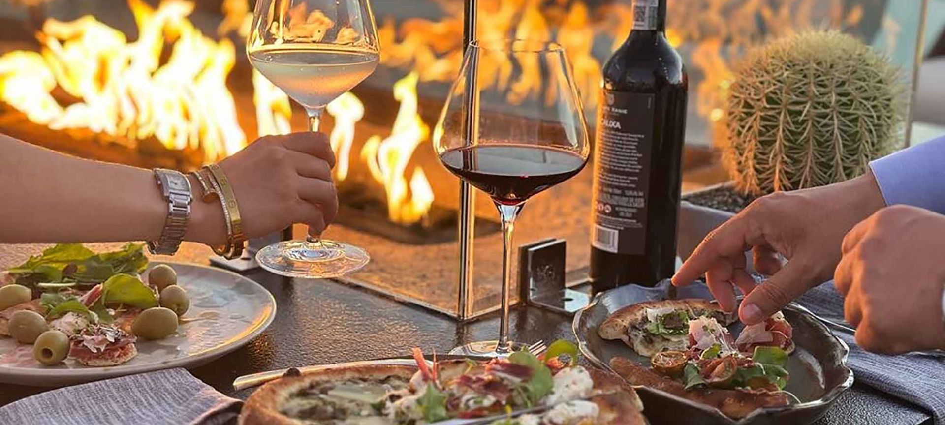 People Are Eating Pizza And Drinking Wine